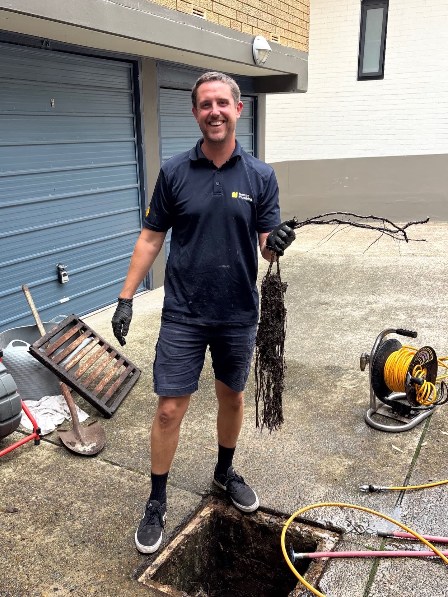 Adam clearing an emergency blocked drain with tree root intrusion