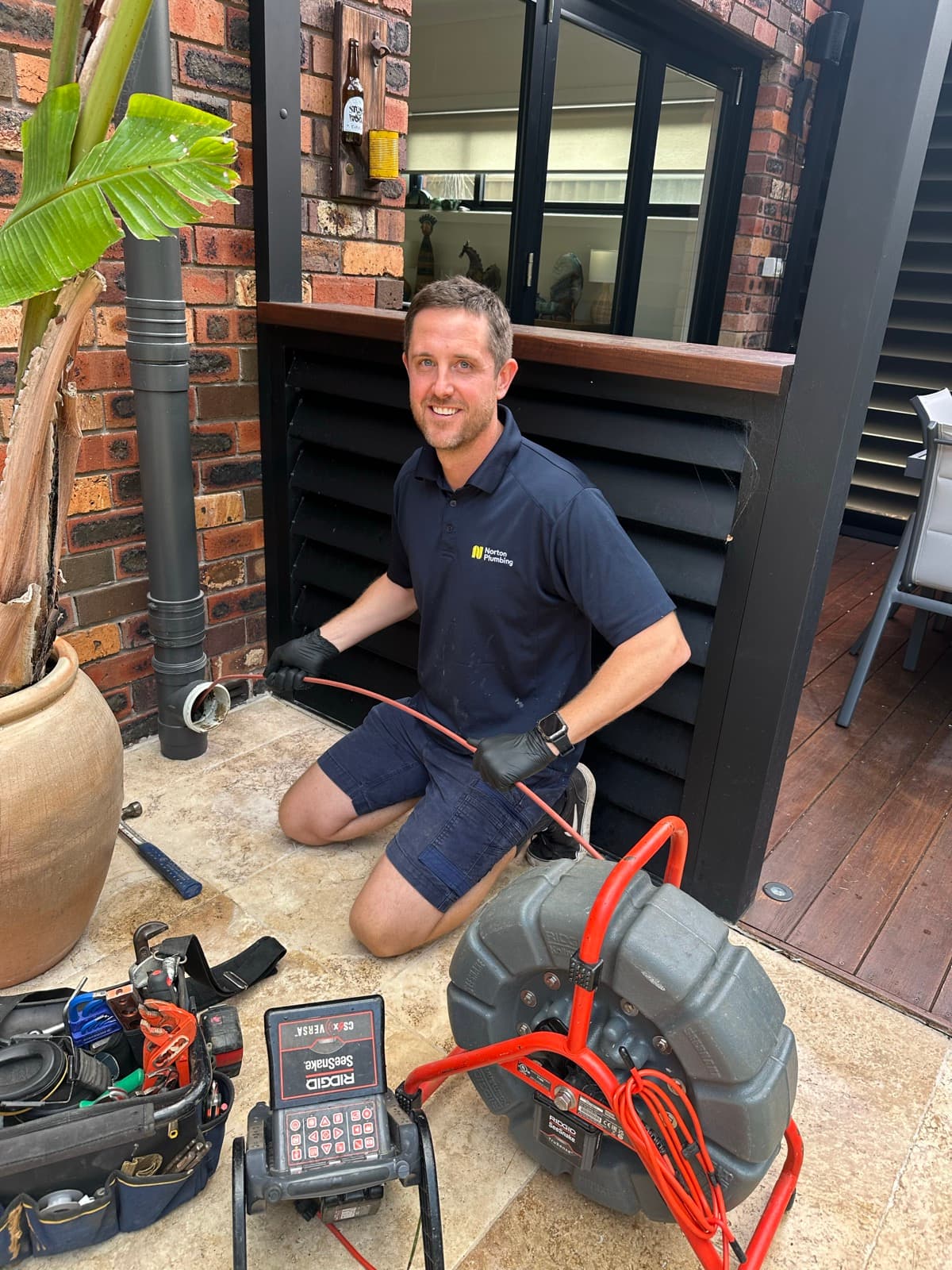 Adam from Norton Plumbing running a CCTV drain camera at a blocked drain job in South Coogee