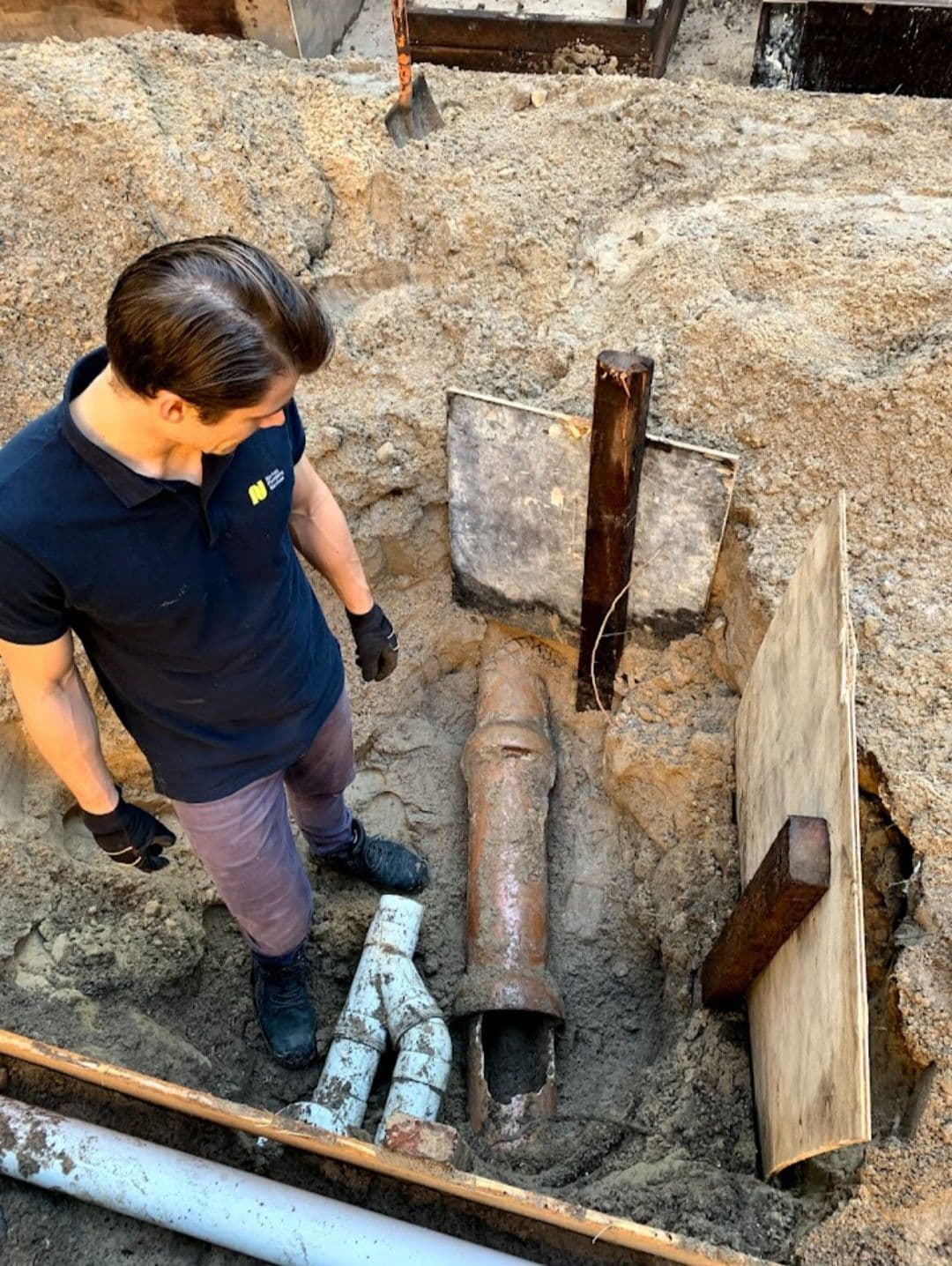Adam inspecting drain pipes