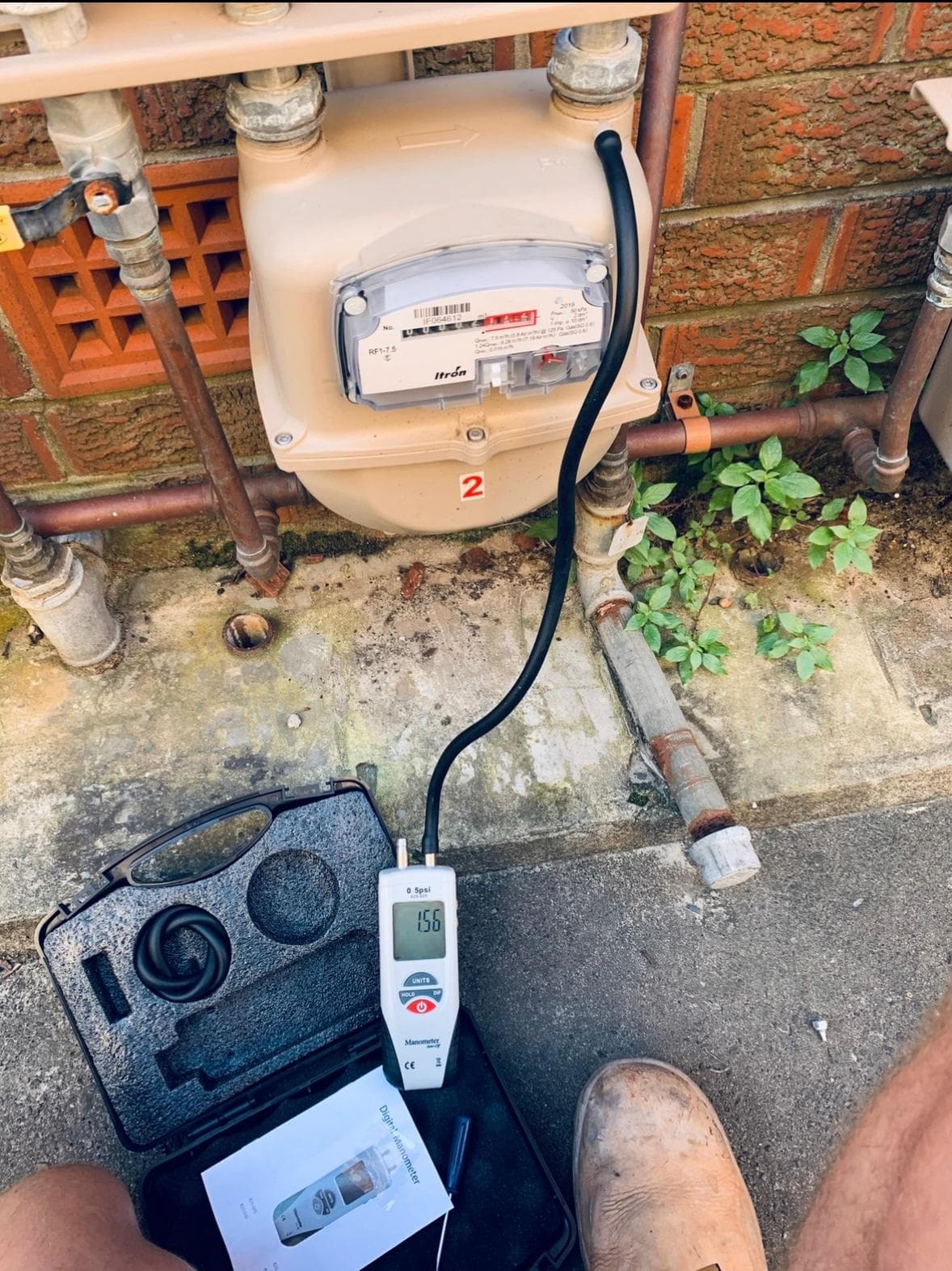 Gas meter with manometer connected for a pressure test, Norton Plumbing gas compliance work