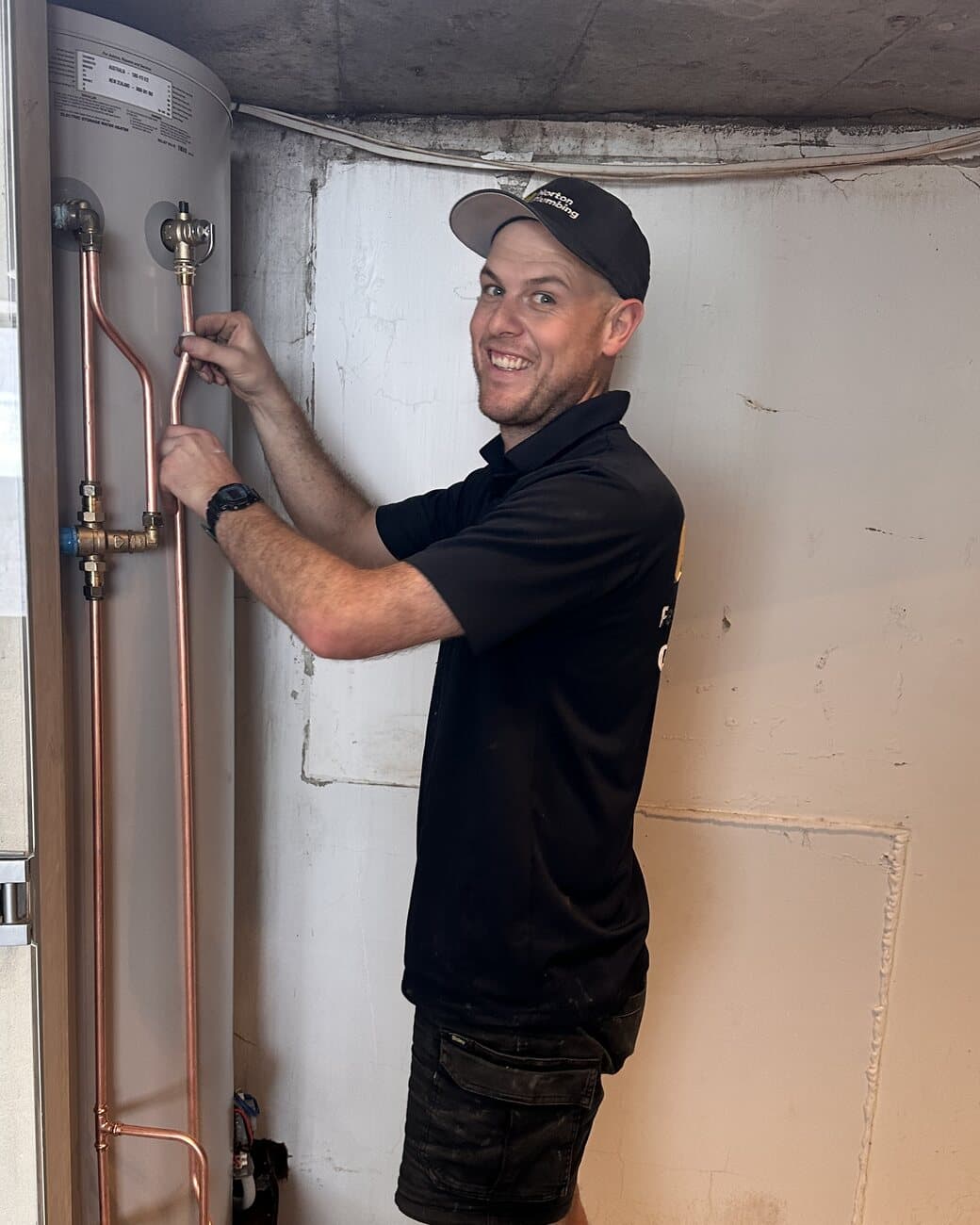 Norton Plumbing plumber connecting copper pipework to a new hot water cylinder, Eastern Suburbs Sydney