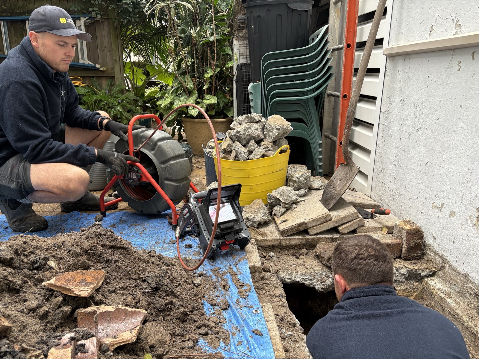 Adam Norton operating RIDGID SeeSnake CCTV drain camera while Greg excavates the blocked drain on Mount Street Coogee