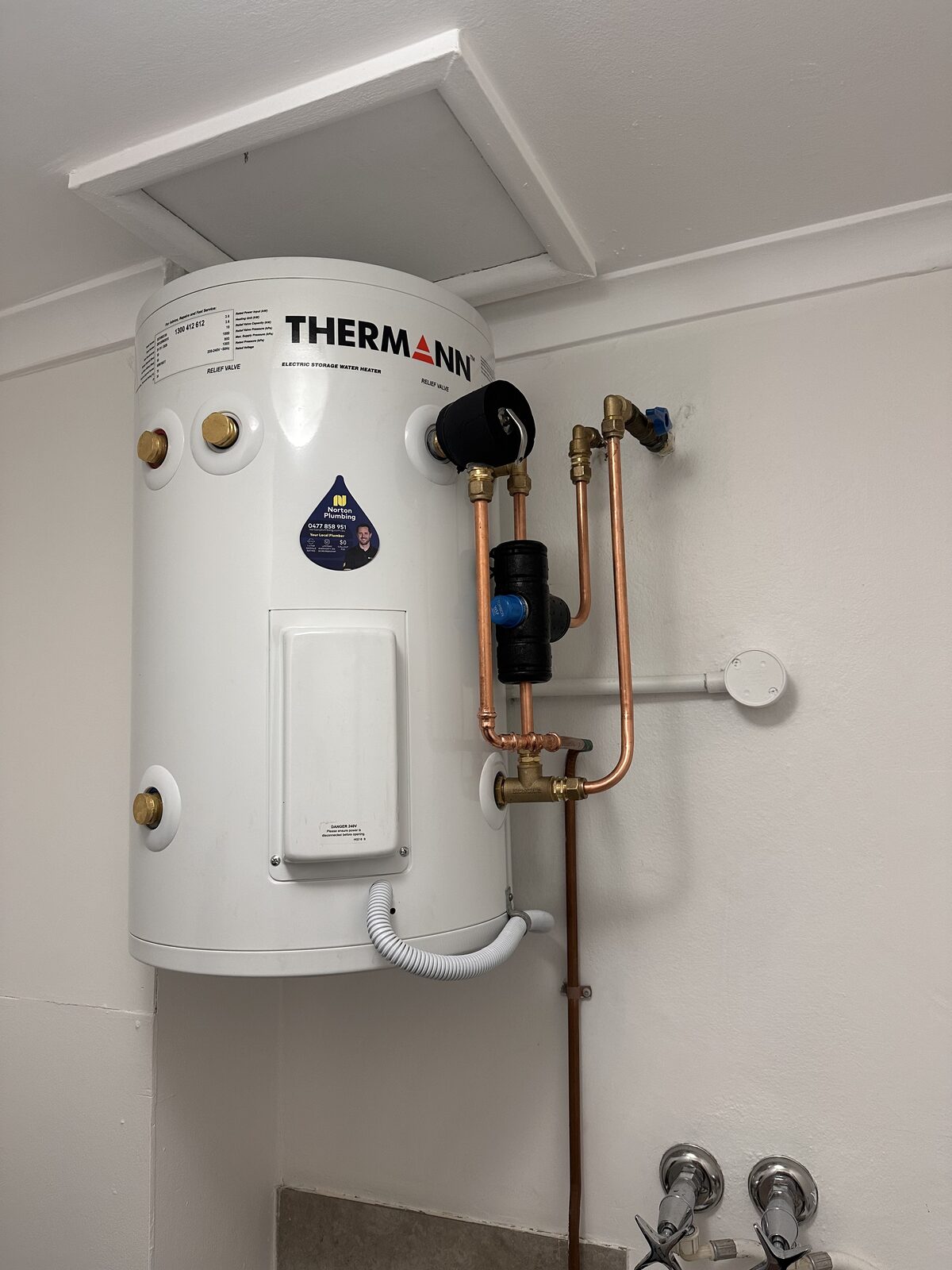 New Thermann electric storage hot water unit in a Coogee laundry with fresh copper pipework to the inlet and outlet, new valves and a new relief valve drain line